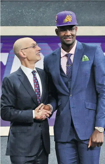  ?? — PHOTOS: THE ASSOCIATED PRESS ?? Arizona’s Deandre Ayton was the first No. 1 pick in Phoenix Suns history when they selected him Thursday during the NBA draft in New York.