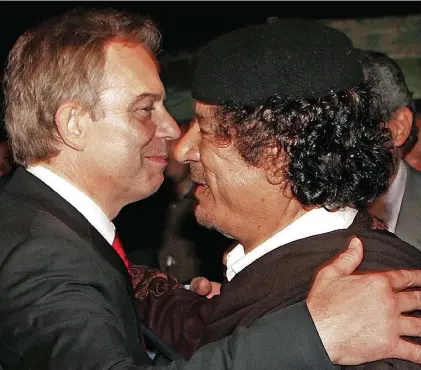  ??  ?? The despot in the desert: Blair is happy to embrace Colonel Gaddafi on a visit to Libya in 2007