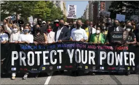  ?? JOSE LUIS MAGANA — THE ASSOCIATED PRESS ?? The Rev. Al Sharpton, third from right in front, holds a banner with Martin Luther King, III, Rep. Sheila Jackson Lee, D-Texas, second from right, and Rep. Al Green, D-Texas, right, among others, during the march to call for sweeping protection­s against a further erosion of the Voting Rights Act of 1965, Saturday, in Washington.