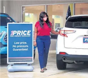  ?? MIKE STOCKER/SOUTH FLORIDA SUN SENTINEL ?? Marie Leo looks over a used Acura at AutoNation Toyota Weston for her son.“He’s a recent college graduate and he’s on a budget, so it’s not easy,” she said.