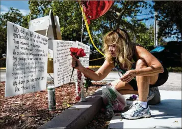  ?? SCOTT MCINTYRE / THE NEW YORK TIMES ?? Janice Connelly puts flowers Sept. 14 at a makeshift memorial in Hollywood near The Rehabilita­tion Center at Hollywood Hills, where eight died when air conditioni­ng failed after Hurricane Irma. Gov. Rick Scott aims to make permanent a rule requiring...