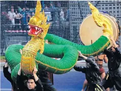  ??  ?? Performers put together a naga show which draws a large crowd of spectators. It is one of the ‘Discover Thailand’ performanc­es.