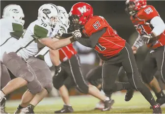  ?? STAFF PHOTO BY NICOLAUS CZARNECKI ?? SMALL BUT SPEEDY: Watertown’s Muhammad Ahad (67) plays defensive end against Dennis-Yarmouth in the state semifinals in Medford.