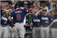  ?? MARTA LAVANDIER — THE ASSOCIATED PRESS ?? U.S. `s Trea Turner (8) salutes his teammates after hitting a home run during the second inning of a World Baseball Classic final game against Japan on Tuesday in Miami.