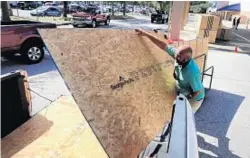  ?? JOE BURBANK/ORLANDO SENTINEL ?? A Lowes customer loads plywood in his truck at a Lowe’s hardware store in Altamonte Springs on Aug. 30, 2019.