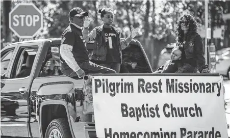  ?? Staff file photo ?? Pastor B.J. Plattenbur­g, left, and co-pastor Rosie Plattenbur­g ride with their children during the Pilgrim Rest Baptist Church Homecoming Parade in 2014 in Conroe. The church recently expanded outreach to help house veterans.