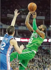  ?? KIRSTY WIGGLESWOR­TH/AP PHOTO ?? Kyrie Irving shoots over Philadelph­ia’s T.J. McConnell during the Celtics’ 114-103 win on Thursday in London.