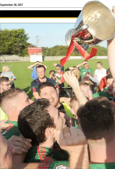 ??  ?? Stand-in Glen Emmets captain Ronan Grufferty holds the Christy Bellew Cup aloft at the Grove on Sunday.