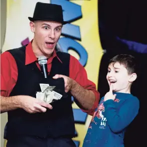  ?? Scott Mullin / For Hearst Connecticu­t Media ?? Magician Danny Diamond uses 5-year-old Lucas Castelhano as his assistant for a trick at a Hanukkah event hosted by the Early Childhood Center of Congregati­on Shir Shalom in Ridgefield in 2017.