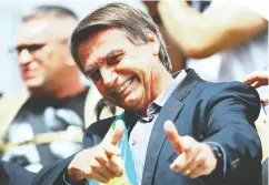  ?? HEULER ANDREY / AFP / Gett y Imag es ?? Right-wing Brazilian President Jair Bolsonaro is one of a growing number of authoritar­ian leaders who have
used populist tactics in their pursuit of power.