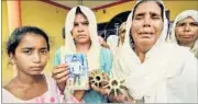  ?? PTI ?? Relatives of Sanjay Kumar, who was killed in cross-border firing, show the tail of mortar shells at Hamirpur Kona on Wednesday.