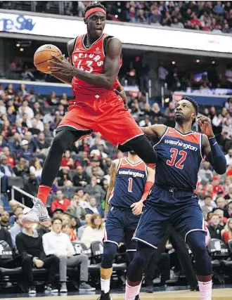  ?? NICK WASS/THE ASSOCIATED PRESS ?? Toronto Raptors forward Pascal Siakam leaps up with the ball against Washington Wizards’ Jeff Green Saturday in Washington. Siakam had 10 points and 10 rebounds coming off the bench.