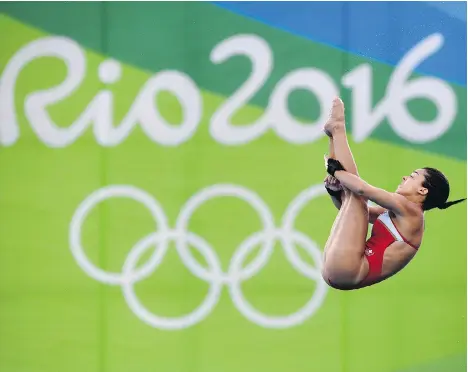  ?? TYLER ANDERSON ?? Meaghan Benfeito of Montreal competes on her way to a bronze medal in the women’s 10-metre platform diving event Thursday. She stayed calm throughout most of the five rounds of dives by denying herself the chance to look at her position on the board.