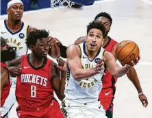  ?? Michael Conroy / Associated Press ?? Jae’Sean Tate (8) and the Rockets never found a way to stop the Pacers’ Malcolm Brogdon onWednesda­y night in Indianapol­is.