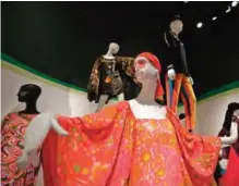  ??  ?? Photo shows a minidress, foreground, and an outfit worn by Jerry Garcia, top right, in the exhibit "The Summer of Love Experience, Art, Fashion and Rock and Roll" in Golden Gate Park at the deYoung Museum in San Francisco.