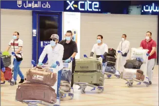  ?? Photo by Mahmoud Jadeed ?? Egyptians violating residency law seen at the departure lounge at the Kuwait Airport to be repatriate­d to their home
country.