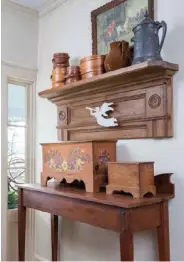  ??  ?? The refurbishe­d mantel shelf hanging in the front hall was salvaged from the kitchen fireplace, which Lynda and Clifford removed during the renovation. It’s the perfect spot to showcase favorite primitive treasures.