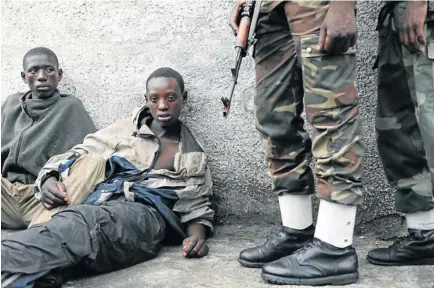  ?? Picture: JAMES OATWAY ?? IN LIMBO: Patrick Micumiza, 15, and Olivier Nzayisenga, 14, say they were herding cattle in Rwanda when they were forced at gunpoint into the M23 army and made to fight in the DRC. They are now enemy captives of the Congolese military in Goma