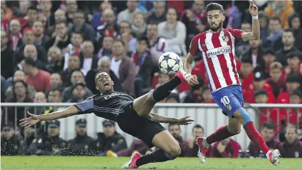  ?? GETTY IMAGES ?? Real Madrid’s Danilo, left, directs the ball away from Atletico’s Yannick Carrasco during their Champions League semifinal second-leg match on Wednesday at the Vicente Calderon Stadium. Madrid moves on to face Juventus in the final despite the 2-1 loss to their Spanish rivals.