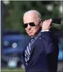  ?? Anna Moneymaker / Getty Images ?? President Joe Biden removes his face mask as he walks to Marine One for a departure from the Ellipse near the White House on May 19 in Washington, D.C.