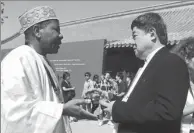  ?? JIANG DONG / CHINA DAILY ?? Shan Jixiang, director of the Palace Museum (right), talks to Edmond Moukala, chief of the Africa unit of the UNESCO World Heritage Centre after the opening of the second Taihe Forum in Beijing on Wednesday.