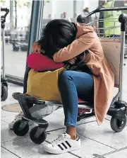  ?? /Reuters ?? Road to nowhere: A woman sleeps on a luggage trolley at Heathrow Terminal 5 in London on Sunday.