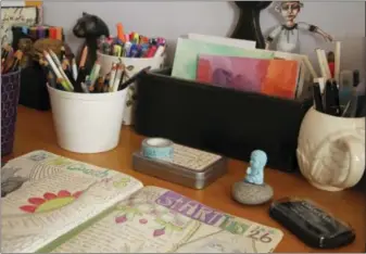  ?? JAMIE RIDLER — JAMIE RIDLER STUDIOS VIA AP ?? A Fauxbonich­i style journal on a desk with journaling supplies