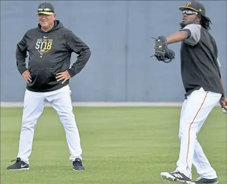  ?? Matt Freed/Post-Gazette ?? Josh Bell warms up next to manager Clint Hurdle during a morning workout at spring training in Bradenton, Fla. Bell typically arrives at LECOM Park about 6:50 a.m., and wouldn’t mind following the lead of other teams and starting later.