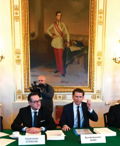  ??  ?? Holding court in Vienna after winning the election on an anti-immigratio­n platform, newly sworn-in Chancellor Sebastian Kurz (right) and Austria’s new Vice Chancellor Heinz-Christian Strache attend their first cabinet meeting