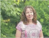  ?? PATRICK SEMANSKY/AP ?? Julie Akey in her back yard in Herndon, Virginia. Now 50, she arrived at Fort Ord in 1996 with a gift for linguistic­s. She enlisted in the Army aiming to learn a new language.