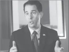  ?? Gerald Herbert / aP ?? Wisconsin Gov. Scott Walker talks during an interview with the Associated Press in New Orleans. Walker recently praised legislatio­n he signed that requires an ultrasound before an abortion.