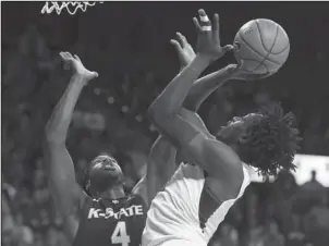  ?? The Associated Press ?? GOING UP FOR TWO: Baylor forward Johnathan Motley, right, shoots over Kansas State forward D.J. Johnson, left, Saturday in Waco, Texas. Kansas State defeated Baylor 56-54.