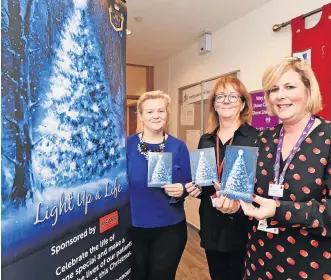  ?? ?? Time for reflection The hospice’s Louise O’donnell (left) and Lorna Mccafferty (right) and Maggie Burns from Mears during a previous Light Up a Life campaign launch