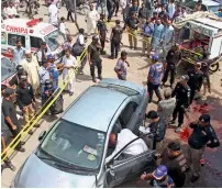  ?? Reuters ?? Police officers inspect the car of religious scholar taqi Usmani after the attack in Karachi. —