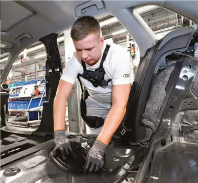  ??  ?? Above: The exoskeleto­ns are being used in various installati­on processes around the vehicle, including the interior and fitment of brake lines.