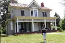  ?? RYAN HALLETT/NATIONAL PARK FOUNDATION VIA AP ?? This June 15 photo shows gymnast and Olympic gold medalist Dominique Dawes visiting the Frederick Douglass house in Washington, D.C., as an ambassador for the National Park Service. The National Park Service is marking its 101st birthday amid a “Parks...