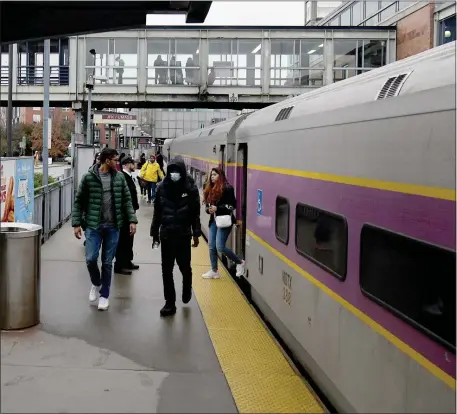  ?? PHOTO BY JIM MICHAUD — BOSTON HERALD ?? Passengers get off the train at JFK Station, Sunday, November 13, 2022, in Boston.