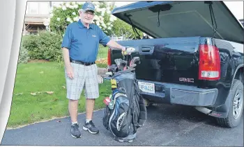  ?? JULIE COLLINS/CAPE BRETON POST ?? Senior amateur golfer George MacDougall puts his clubs in the back of his truck last week for one last game at the Seaview course in North Sydney before heading to Minnesota to volunteer at the Ryder Cup golf competitio­n.
