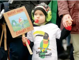  ?? AFP ?? Three-year-old Jonne holds a poster reading “Save my future” and wears a shirt reading “Save the rain forest” as he demonstrat­es for the protection of the environmen­t in a “Fridays for Future” protest on in Duesseldor­f, western Germany. —