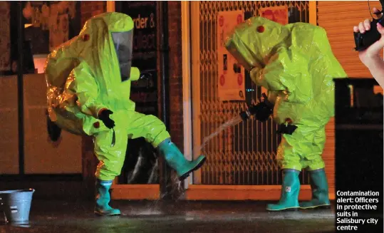  ??  ?? Contaminat­ion alert: Officers in protective suits in Salisbury city centre