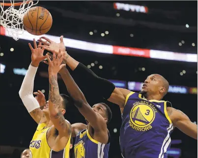  ?? CHRIS CARLSON — ASSOCIATED PRESS; BELOW: HARRY HOW — GETTY IMAGES ?? Warriors forward David West, right, knocks the ball away from Los Angeles Lakers forward Kyle Kuzma, left, during the first half.
