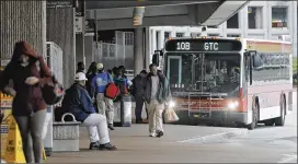  ?? BOB ANDRES/BANDRES@AJC.COM 2017 ?? MARTA passengers board a Gwinnett Transit bus at the Doraville station in April 2017. The potential contract between Gwinnett and MARTA provides several provisions to protect the use of Gwinnett sales tax revenue, county officials said.