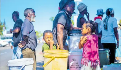  ?? AP ?? Residents of the township of Soweto, South Africa, queue for water on March 16.