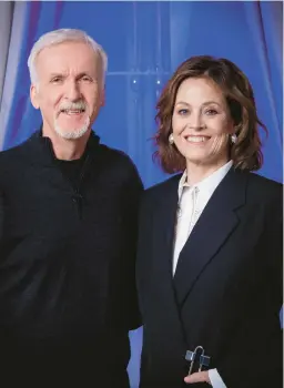  ?? VIANNEY LE CAER/INVISION ?? James Cameron and Sigourney Weaver of “Avatar: The Way of Water” are seen Dec. 4 in London.