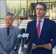  ?? CALEB JONES / ASSOCIATED PRESS ?? Paul Delacourt (right), head of the FBI bureau in Hawaii, speaks Monday outside the federal courthouse in Honolulu about the arrest of Sgt. Ikaika Kang. U.S. Attorney Elliot Enoki is at left.