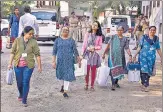  ?? PTI ?? Polling officials with EVMs and other equipment leave for their polling stations ahead of the first phase of Gujarat elections.