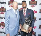  ?? [PHOTO BY EDDIE PERLAS, ESPN IMAGES] ?? OU star Buddy Hield poses Friday night with Jerry West after winning the John R. Wooden Award, given to college basketball’s top player. Hield also won the Jerry West Award, given to college basketball’s top shooting guard.