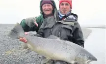  ??  ?? OFF THE SCALES Paul and fellow angler with mammoth sea trout