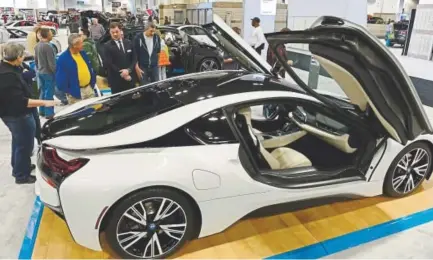  ?? Helen H. Richardson, Denver Post file ?? People check out the 2015 BMW i8 Hybrid car at the 2015 Denver Auto Show in Denver.