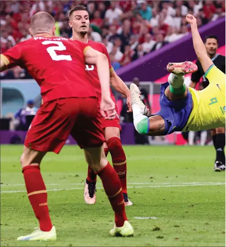  ?? ?? Richarliso­n rises to thump home an aerial effort pundits are hailing as the goal of the tournament so far as